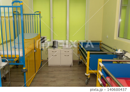 Pediatric hospital ward with colorful blue and yellow infant cribs and medical monitoring equipment. Pediatric hospital ward with colorful blue and yellow infant cribs and medical monitoring equipment. 140680437