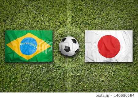 Brazil vs. Japan flags on soccer field 140680594