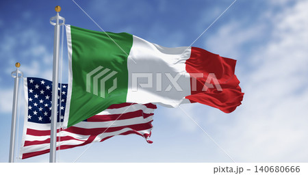 National flag of Italy waving in the wind with the US flag on a clear day National flag of Italy waving in the wind with the US flag on a clear day 140680666