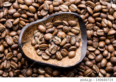 Roasted coffee beans with wooden spoon, closeup image, space for text Roasted coffee beans with wooden spoon, closeup image, space for text 140680714