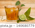 glass with lemon tea on wood 140680779