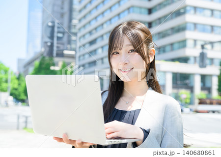 ビル街でノートパソコンを使う日本人女性 ビル街でノートパソコンを使う日本人女性 140680861