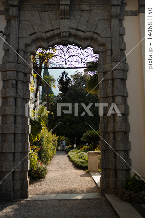 Beautiful park view framed by an ancient stone archway Beautiful park view framed by an ancient stone archway 140681150
