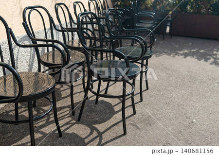 Empty bistro chairs on outdoor cafe terrace background 140681156