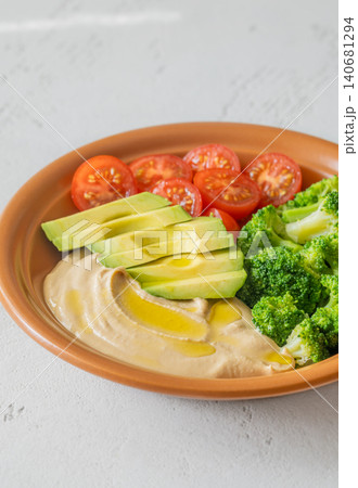 Healthy Hummus Bowl With Avocado Broccoli And Cherry Tomatoes Healthy Hummus Bowl With Avocado Broccoli And Cherry Tomatoes 140681294
