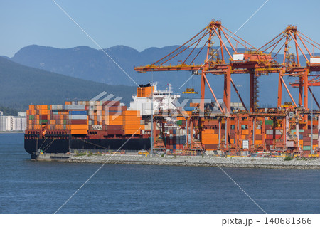 Cargo ship at container port loading global trade goods Cargo ship at container port loading global trade goods 140681366