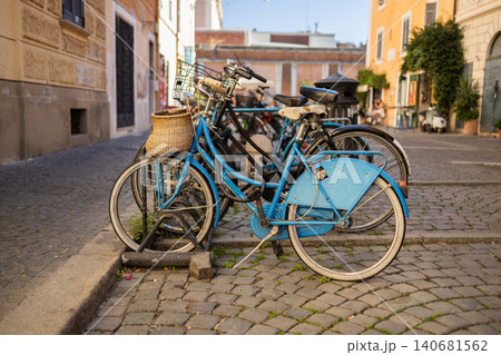Vintage bicycles parked on cobblestone street in old European town 140681562
