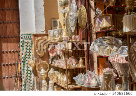 Handcrafted metal lanterns hang at the entrances of shops in an alleyway in Fez, Morocco. Handcrafted metal lanterns hang at the entrances of shops in an alleyway in Fez, Morocco. 140681666