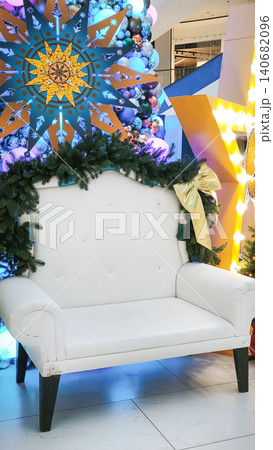 white armchair surrounded by Christmas wreath and bright decorations, 140682096
