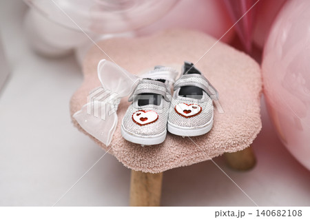 tiny girl shoes with bows on plush pink stool, tiny girl shoes with bows on plush pink stool, 140682108