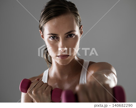 Serious woman, portrait and fitness with dumbbells for weightlifting, workout or exercise on a gray studio background. Female person, bodybuilder or athlete with small barbells for training on mockup Serious woman, portrait and fitness with dumbbells for weightlifting, workout or exercise on a gray studio background. Female person, bodybuilder or athlete with small barbells for training on mockup 140682290