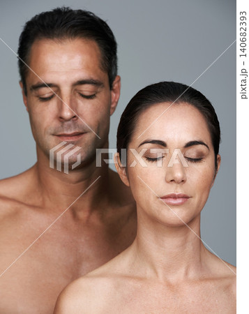 Couple, eyes closed and skincare in studio, beauty and collagen cosmetics for anti aging. Mature people, facial treatment and dermatology for health on gray background, love and together for wellness Couple, eyes closed and skincare in studio, beauty and collagen cosmetics for anti aging. Mature people, facial treatment and dermatology for health on gray background, love and together for wellness 140682393