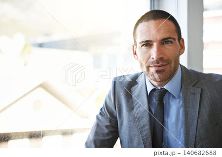 Business man, portrait and corporate professional in an office ready for work at a company window. Serious, suit and investment manager with confidence at an accounting firm with a male executive 140682688