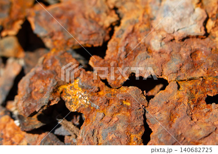 Rust corrosion metal texture iron oxide peeling surface closeup of weathered steel with flaky red patina and rough cracked detail, gritty industrial background for decay concept Rust corrosion metal texture iron oxide peeling surface closeup of weathered steel with flaky red patina and rough cracked detail, gritty industrial background for decay concept 140682725