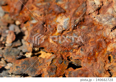 Rust rock texture iron oxide mineral stone corrosion geology background macro detail of rugged orange brown surface, cracked patina and weathering on natural ore, abstract backdrop 140682728