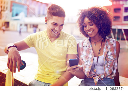 Interracial couple, skatepark and smartphone for online post, social media or communication in city. Skateboard, happy man and woman with mobile phone for memories, weekend trip and networking Interracial couple, skatepark and smartphone for online post, social media or communication in city. Skateboard, happy man and woman with mobile phone for memories, weekend trip and networking 140682874