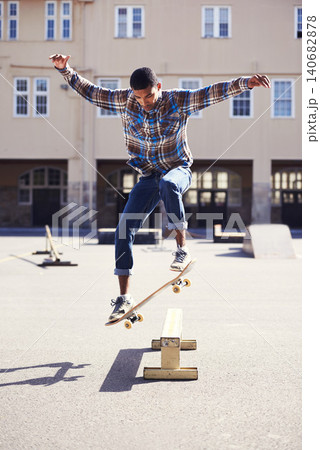 Man, skateboard and jumping at urban skatepark, sports and energy with skill, stunt and recreation activity outdoor. Skateboarder, confidence and trick, training and workout for balance and exercise 140682878