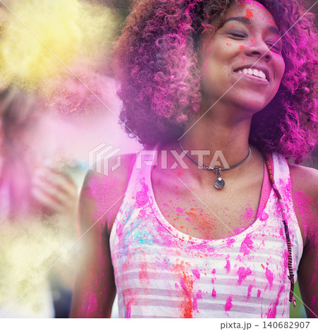 Powder, paint and woman at color festival in park, happiness and fun with celebration or party outdoor. Freedom, excited and colorful mess, smile with joy and culture, positivity and summer event 140682907