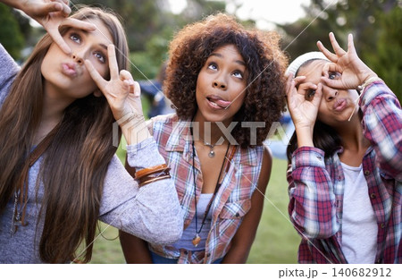 Funny, face and friends in a park with silly, fun or bonding on vacation, weekend or reunion in nature. Crazy, expression and gen z women in a forest with goofy, comic or personality, joke or gesture Funny, face and friends in a park with silly, fun or bonding on vacation, weekend or reunion in nature. Crazy, expression and gen z women in a forest with goofy, comic or personality, joke or gesture 140682912