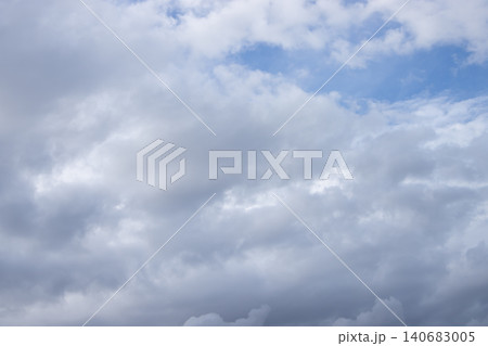 Cloud sky overcast cumulus weather blue gray cloudscape, soft layered clouds drift across open atmosphere, calm moody daylight background with copy space for design Cloud sky overcast cumulus weather blue gray cloudscape, soft layered clouds drift across open atmosphere, calm moody daylight background with copy space for design 140683005