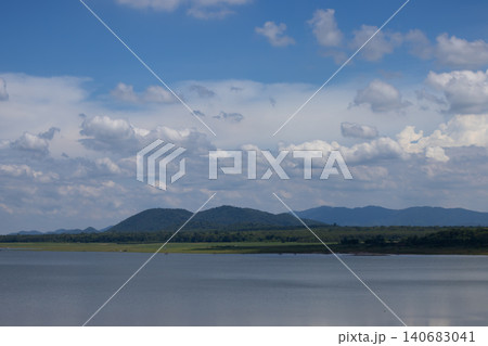 Lake mountain cloud sky water landscape forest horizon, calm reservoir scene with distant ridge under dramatic cumulus, natural travel background with wide copy space Lake mountain cloud sky water landscape forest horizon, calm reservoir scene with distant ridge under dramatic cumulus, natural travel background with wide copy space 140683041