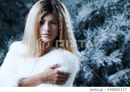 Woman, winter and fashion portrait by tree, attitude and pride for fur coat or warm clothes. Female person, serious face and confident in fluffy jacket or nature, forest and trendy or outdoor outfit Woman, winter and fashion portrait by tree, attitude and pride for fur coat or warm clothes. Female person, serious face and confident in fluffy jacket or nature, forest and trendy or outdoor outfit 140683117