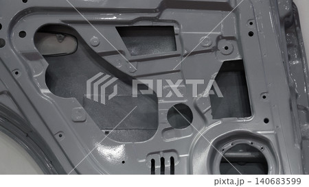Car door metal sheet. Close up automotive door inner panels and stamped steel body parts. Modern vehicle manufacturing facility. Precision metal forming. Metal Car doors automotive assembly technology Car door metal sheet. Close up automotive door inner panels and stamped steel body parts. Modern vehicle manufacturing facility. Precision metal forming. Metal Car doors automotive assembly technology 140683599