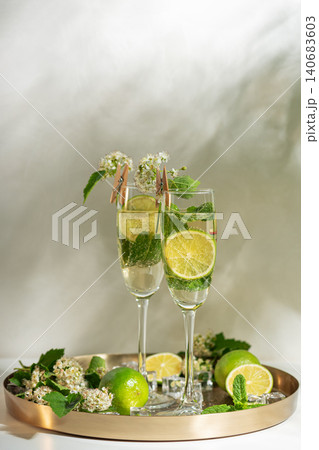 Refreshing summer cocktails with mint and lime on a golden tray Refreshing summer cocktails with mint and lime on a golden tray 140683603