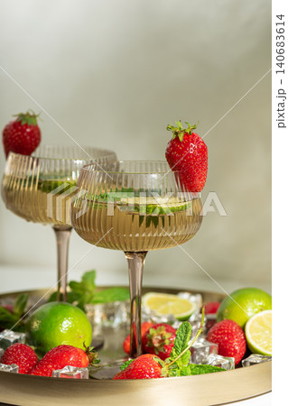 Refreshing strawberry cocktails with lime and mint on a tray Refreshing strawberry cocktails with lime and mint on a tray 140683614