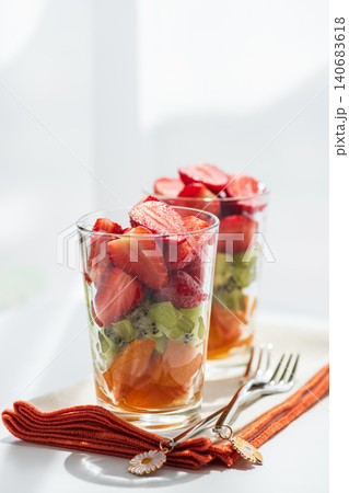 Fresh fruit salad in glasses with kiwi strawberries and orange segments Fresh fruit salad in glasses with kiwi strawberries and orange segments 140683618