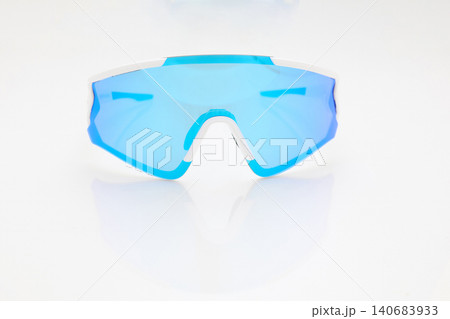stylish sunglasses on a glossy white table, blue glass, white sunglasses frame, yachting glasses, cycling glasses, reflection on a glossy surface stylish sunglasses on a glossy white table, blue glass, white sunglasses frame, yachting glasses, cycling glasses, reflection on a glossy surface 140683933
