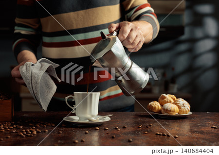 Profiteroles with mascarpone and cup of black coffee. Profiteroles with mascarpone and cup of black coffee. 140684404