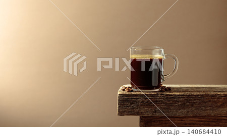 Black coffee on an old wooden table. Black coffee on an old wooden table. 140684410