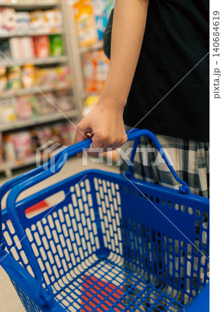 小売店の商品棚を背景にした買い物シーン 140684619