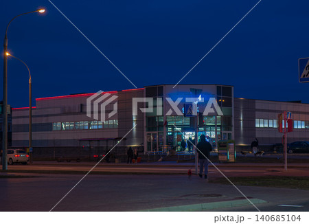 Night street scene at a modern mall in Minsk with blue glass entry 140685104
