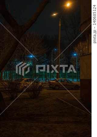 Night street in Minsk with Y shaped lamp, sedans, and apartment block Night street in Minsk with Y shaped lamp, sedans, and apartment block 140685124