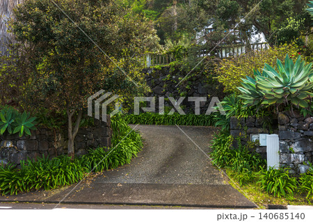 Uphill driveway with basalt walls and agave on Madeira, morning Uphill driveway with basalt walls and agave on Madeira, morning 140685140