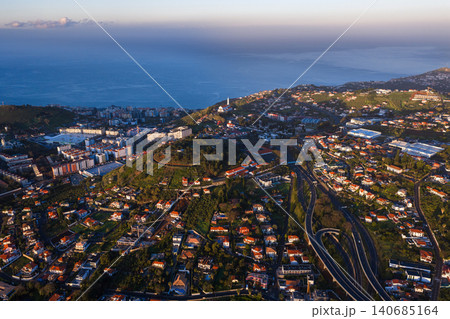 Aerial view of Madeira hillside city with church and Atlantic horizon 140685164