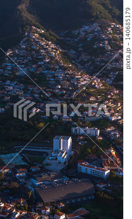 Aerial terraces and landmarks in Madeira hillside town at dusk 140685179