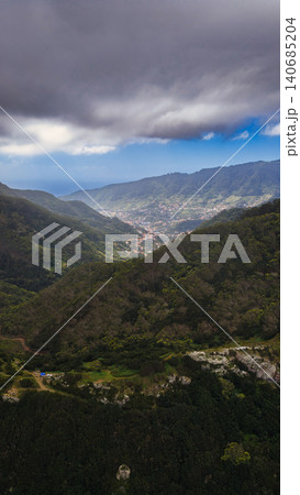 Aerial valley view in Madeira with town, storm clouds, and Atlantic 140685204