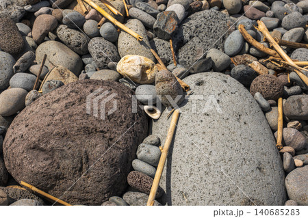 Madeira pebble beach with basalt rocks, driftwood, and Atlantic polish 140685283