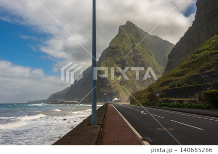 Curving coastal road beneath basalt cliffs on Madeira north coast Curving coastal road beneath basalt cliffs on Madeira north coast 140685286
