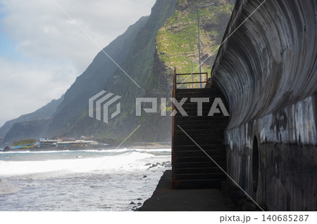 Curving seawall and stairs on Madeira north coast near Seixal 140685287