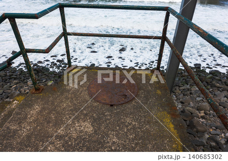 Rust streaked lookout above rocky Atlantic shore in Madeira Rust streaked lookout above rocky Atlantic shore in Madeira 140685302