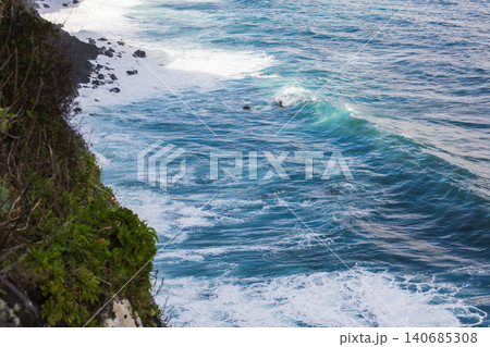 Madeira north coast cliff and Atlantic surf with basalt boulders 140685308