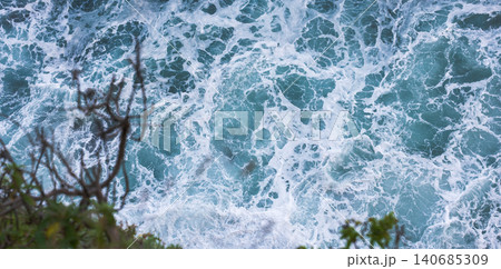 Atlantic surf below Madeira cliff with foaming turquoise waves Atlantic surf below Madeira cliff with foaming turquoise waves 140685309