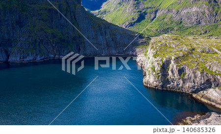 Dramatic Alpine Lake with Steep Cliffs in Lofoten Norway Dramatic Alpine Lake with Steep Cliffs in Lofoten Norway 140685326