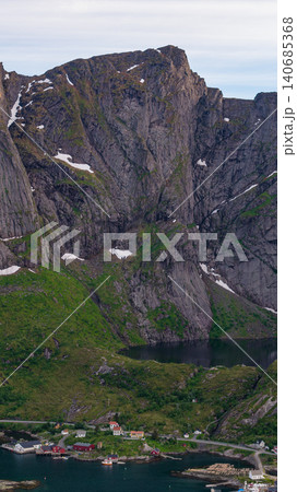 Dramatic Lofoten Mountain Peaks with Coastal Village and Alpine Lake 140685368