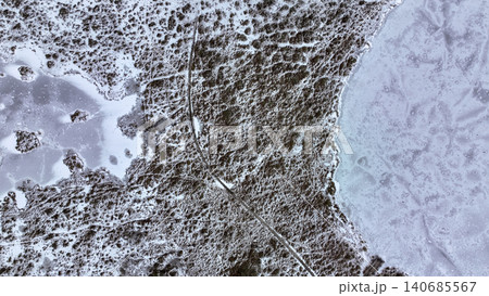 Aerial View of Snowy Landscape with Frozen Lake and Central Path Aerial View of Snowy Landscape with Frozen Lake and Central Path 140685567