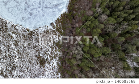 Aerial View of Frozen Lake and Forest with Path in Winter Aerial View of Frozen Lake and Forest with Path in Winter 140685569